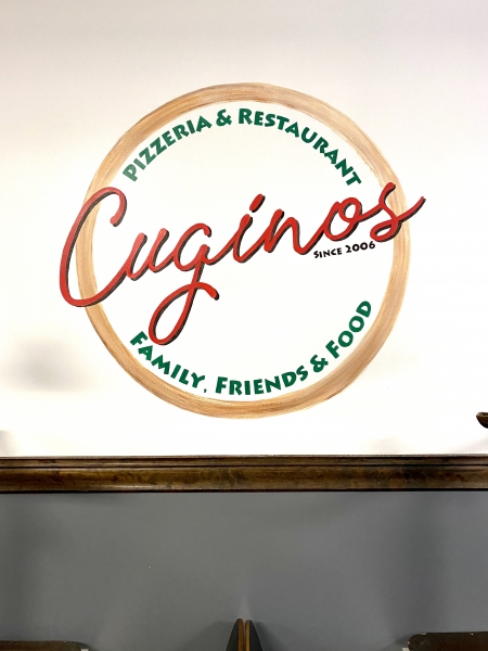 Cuginos Pizzeria logo:  designed and painted on restaurant wall